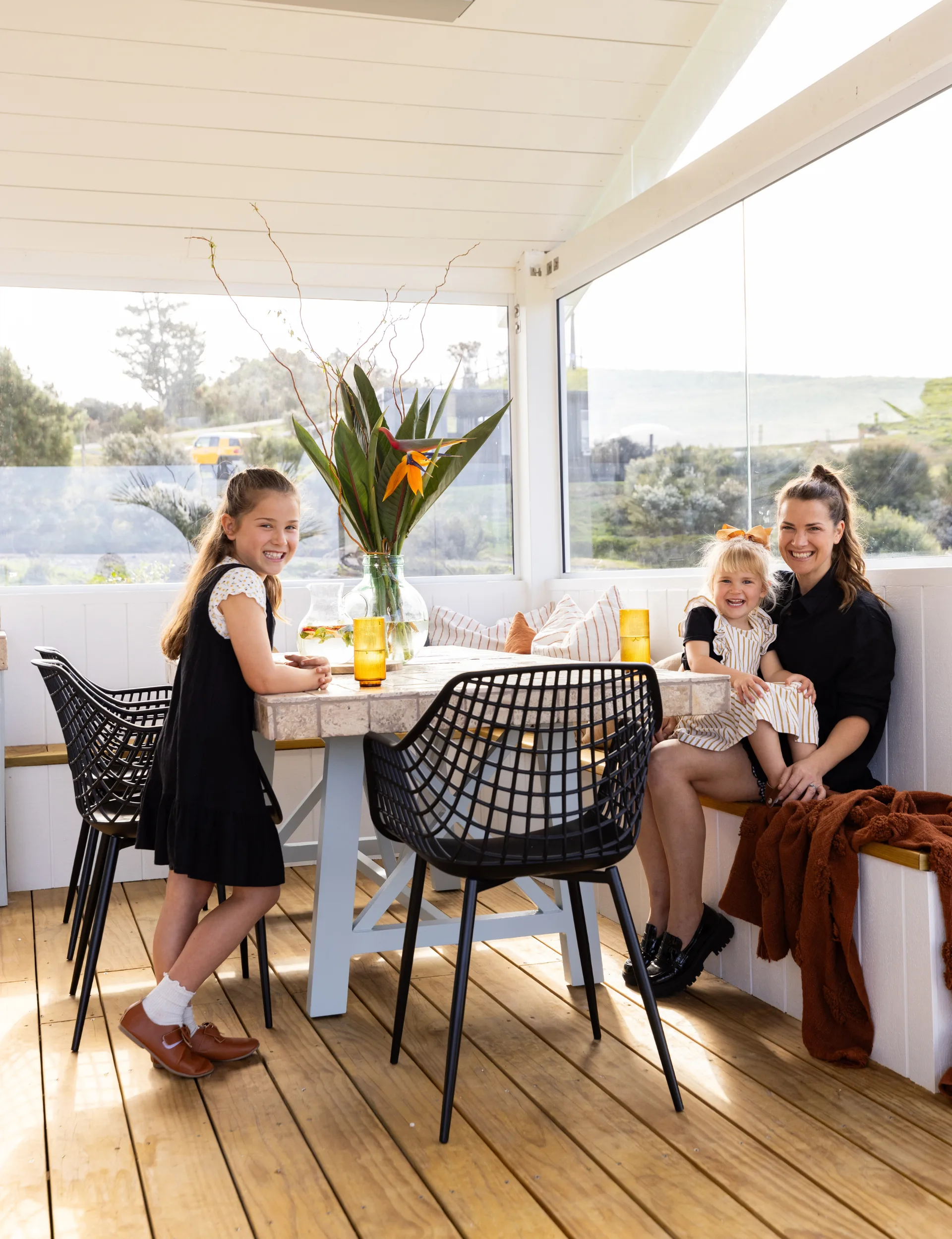 Alice Pearson and her kids in the outdoor space of her parents' home in Hatfields Beach