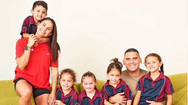 The Kiwi quads with their parents in their school uniforms