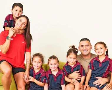 The Kiwi quads with their parents in their school uniforms