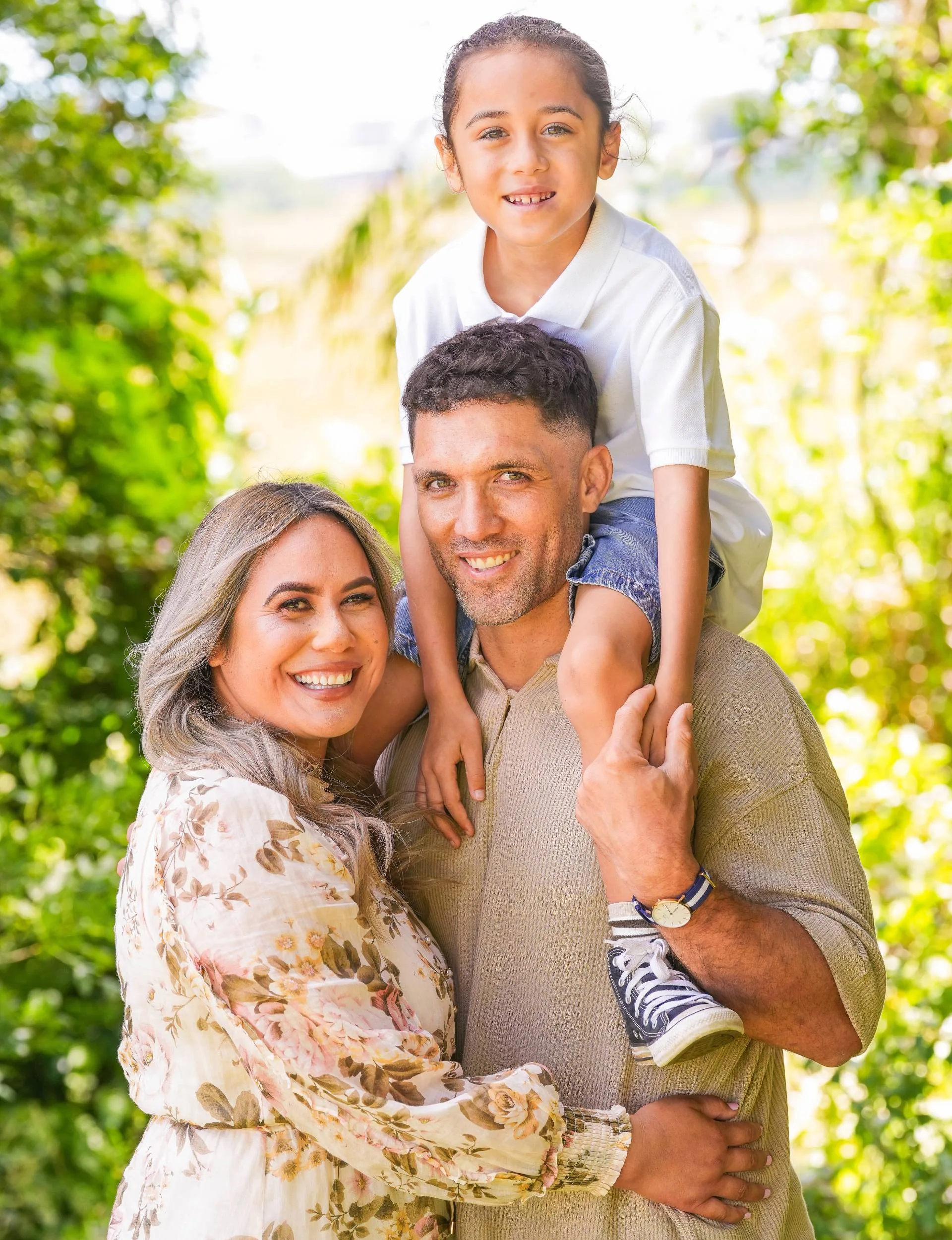 Huriana with her family - son Sāchi on husband Derek's shoulders