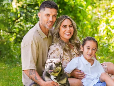 Huriana Manuel with her family on some grass