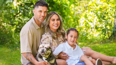 Huriana Manuel with her family on some grass