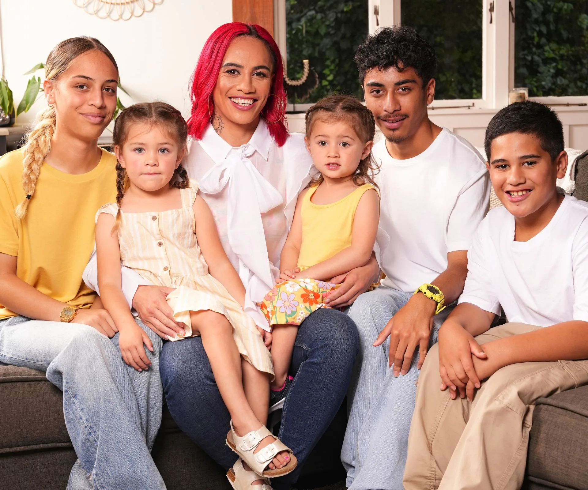 Mea Motu on a couch with her children