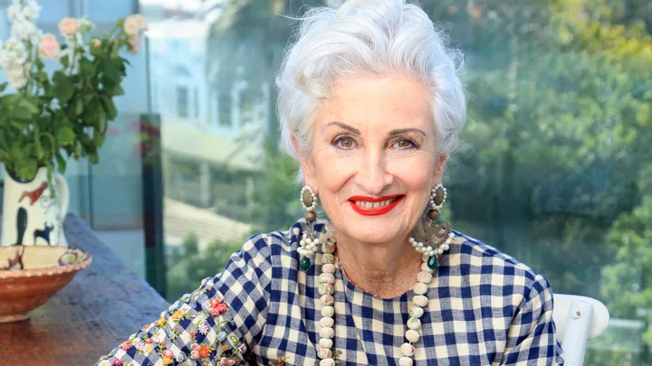 Peta Mathias sitting at a coffee table