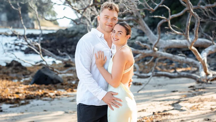 Ollie Norris with fiancée Millie on a beach