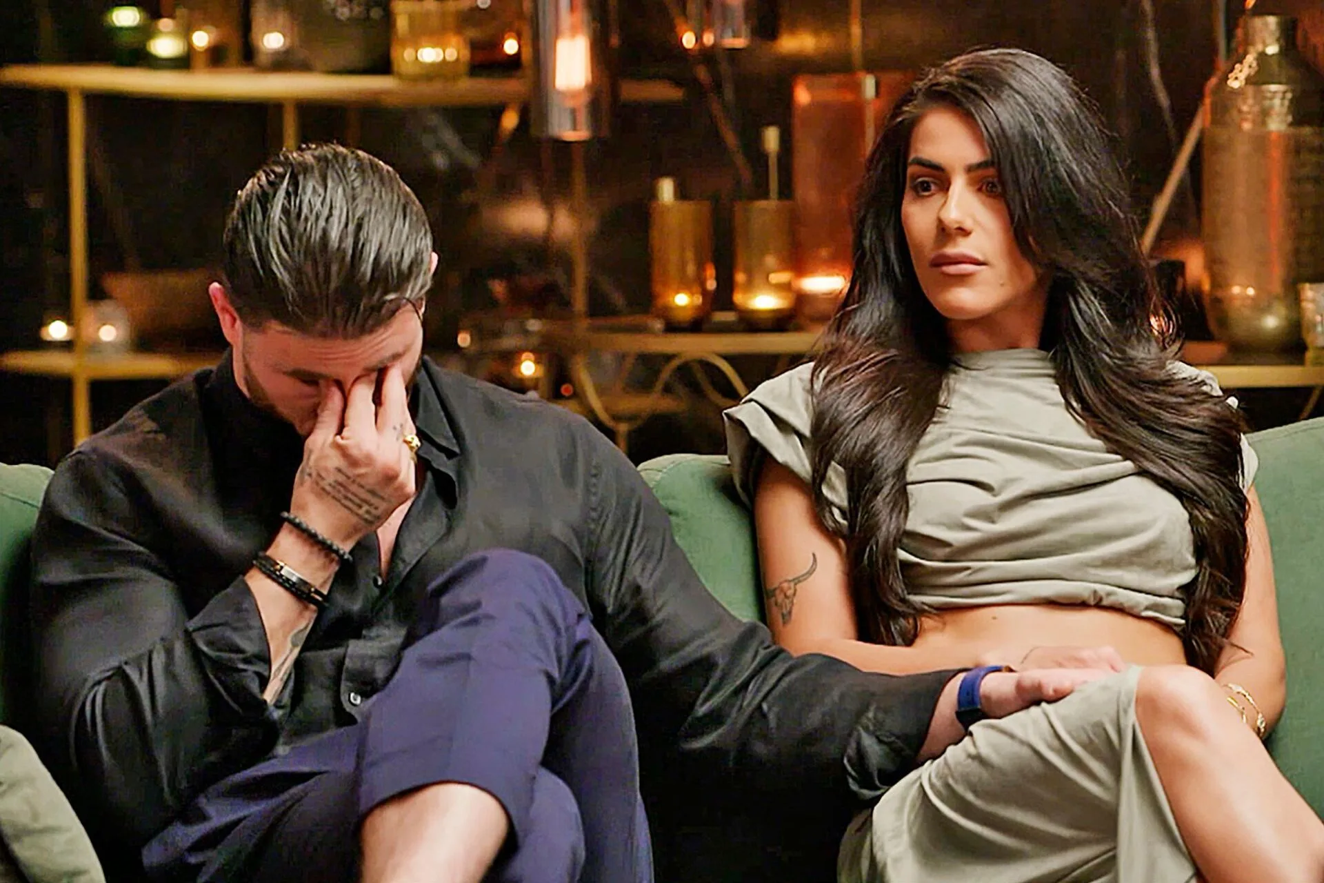 Paul crying on the commitment ceremony couch with his hand on Carina's leg