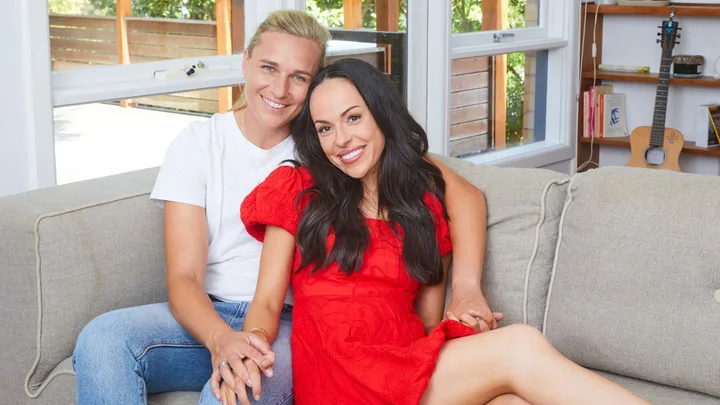 Hannah Wilkinson with her fiancée on a couch