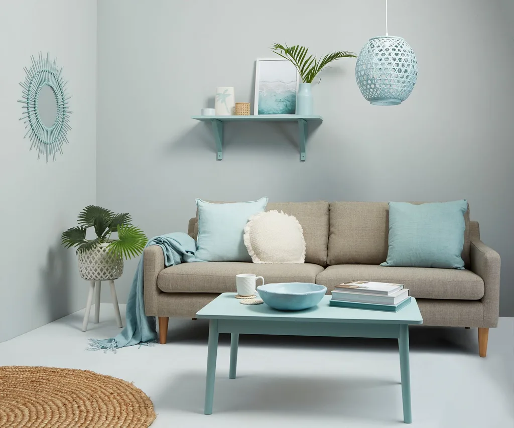 In this warm and inviting contemporary living room, Resene Duck Egg Blue walls and Resene Quarter Duck Egg Blue floors introduce subtle and appealing colour to a space decorated primarily with other pale blues and neutrals