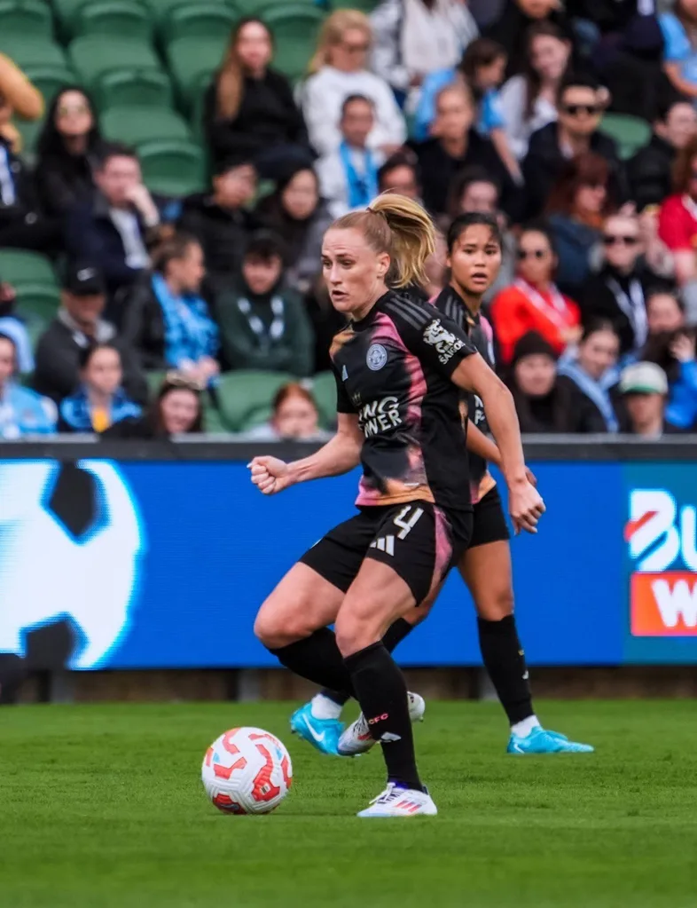 female footballer about to kick a ball