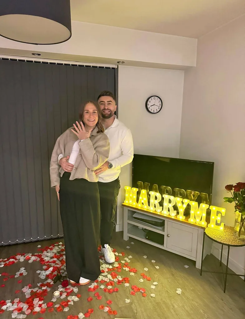 Man proposing to woman in living room