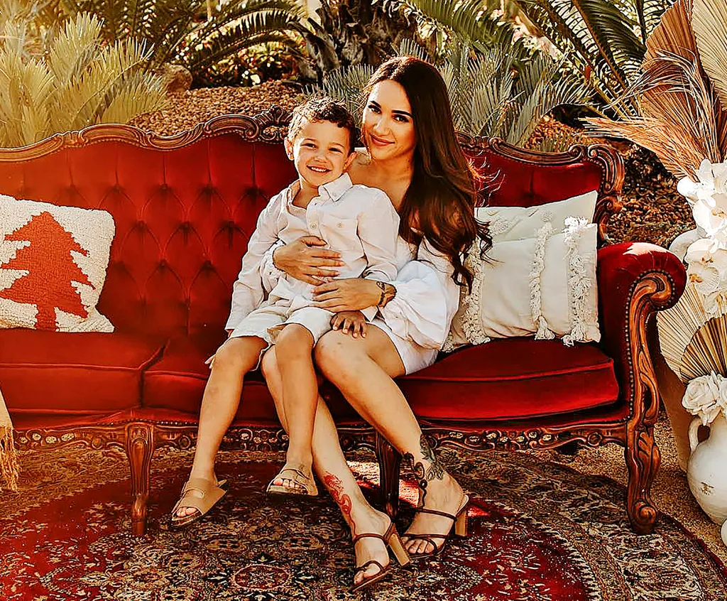 cleo sitting on red velvet couch with nephew on her lap