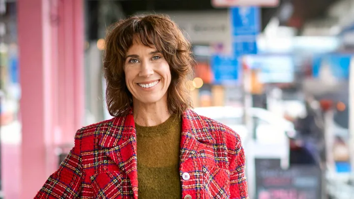 Woman wearing a red plaid jacket standing in food aisle