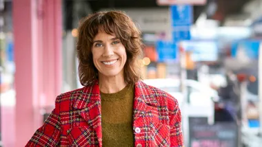 Woman wearing a red plaid jacket standing in food aisle