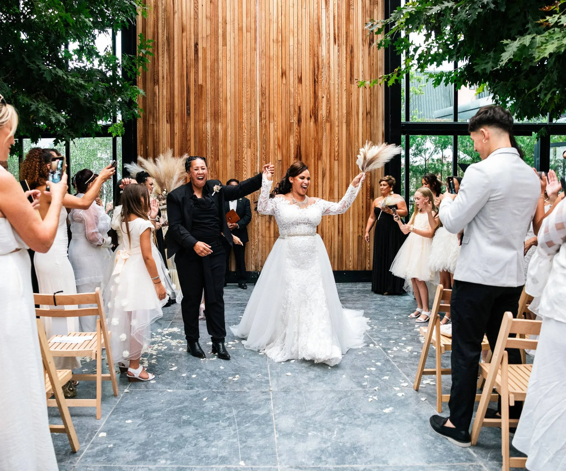 Celebrating as the couple walk out of their wedding ceremony