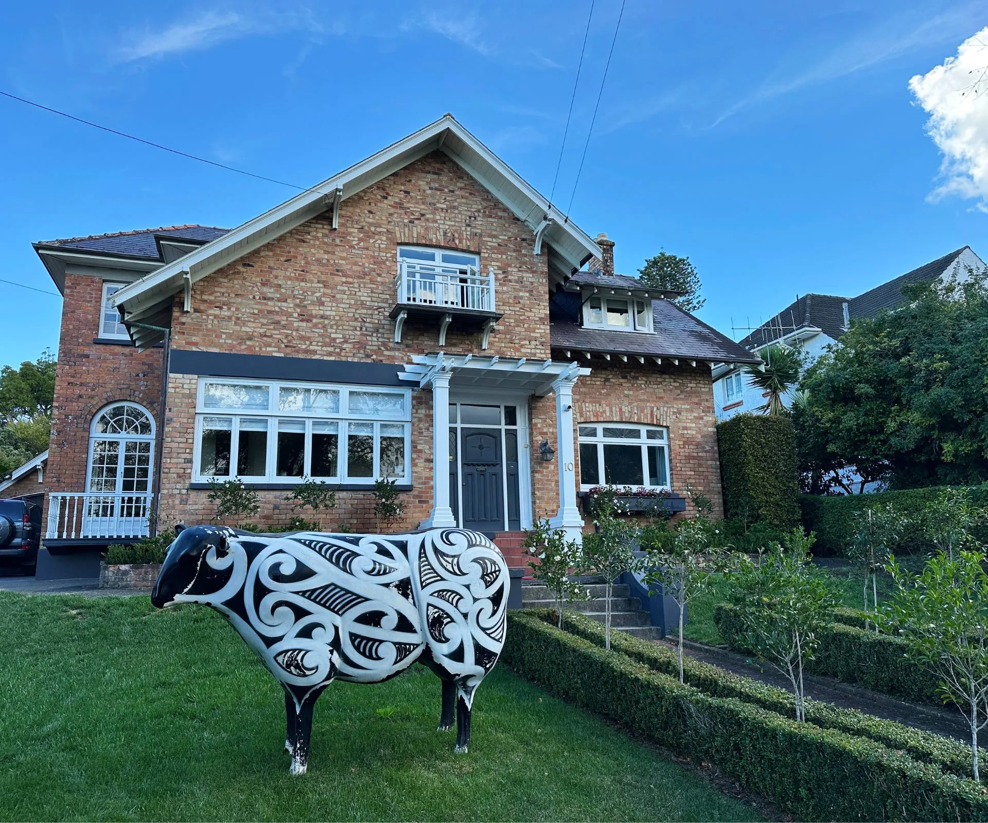 The exterior of Jeremy Corbett's family home with an oversized sheep statue in the front garden