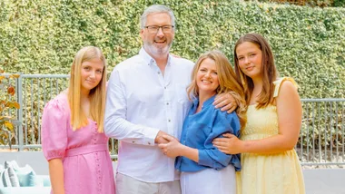 Jeremy Corbett in front of his home pool with his family