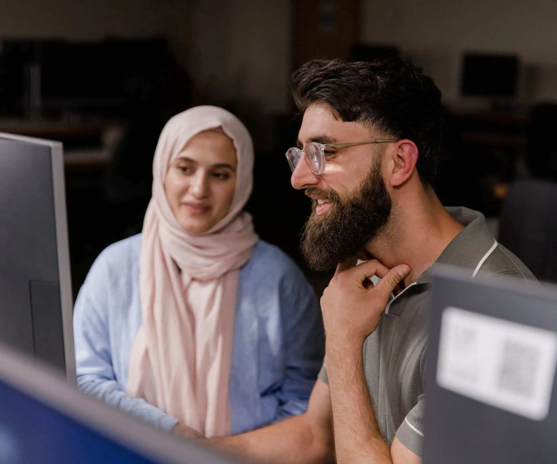 Bariz Shah and Saba Afrasyabi working on computers together