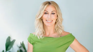 Wendy Petrie posing in a green dress