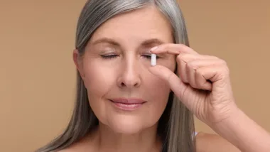 Lady holding pill