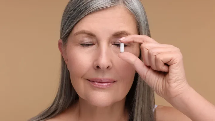 Lady holding pill