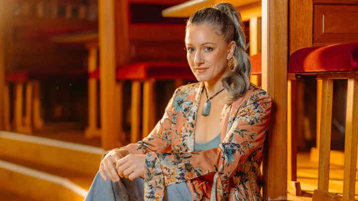 Eve Gordon sitting on the side of her circus stage