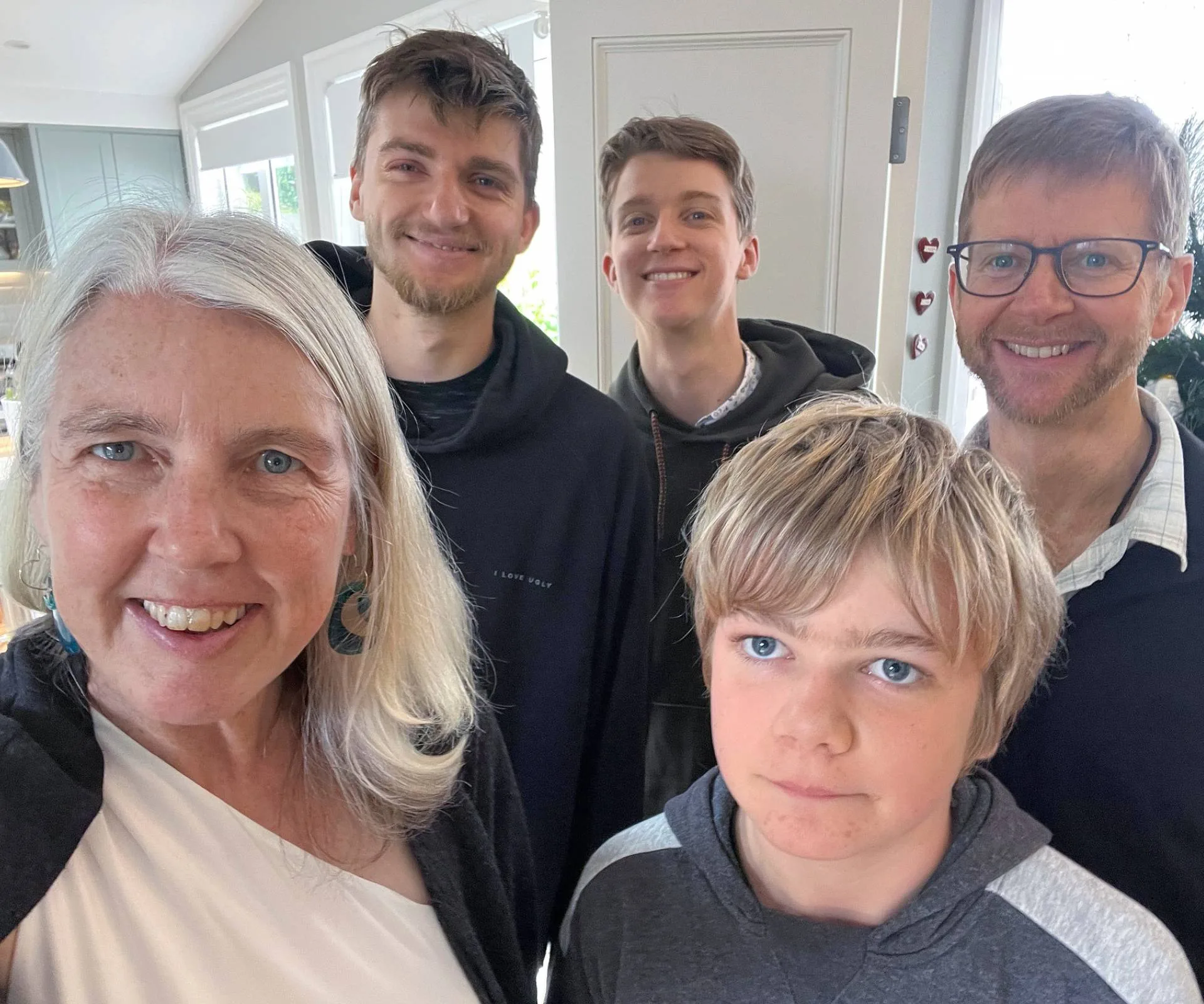 Jennifer Andrewes taking a selfie with her sons and husband in their home