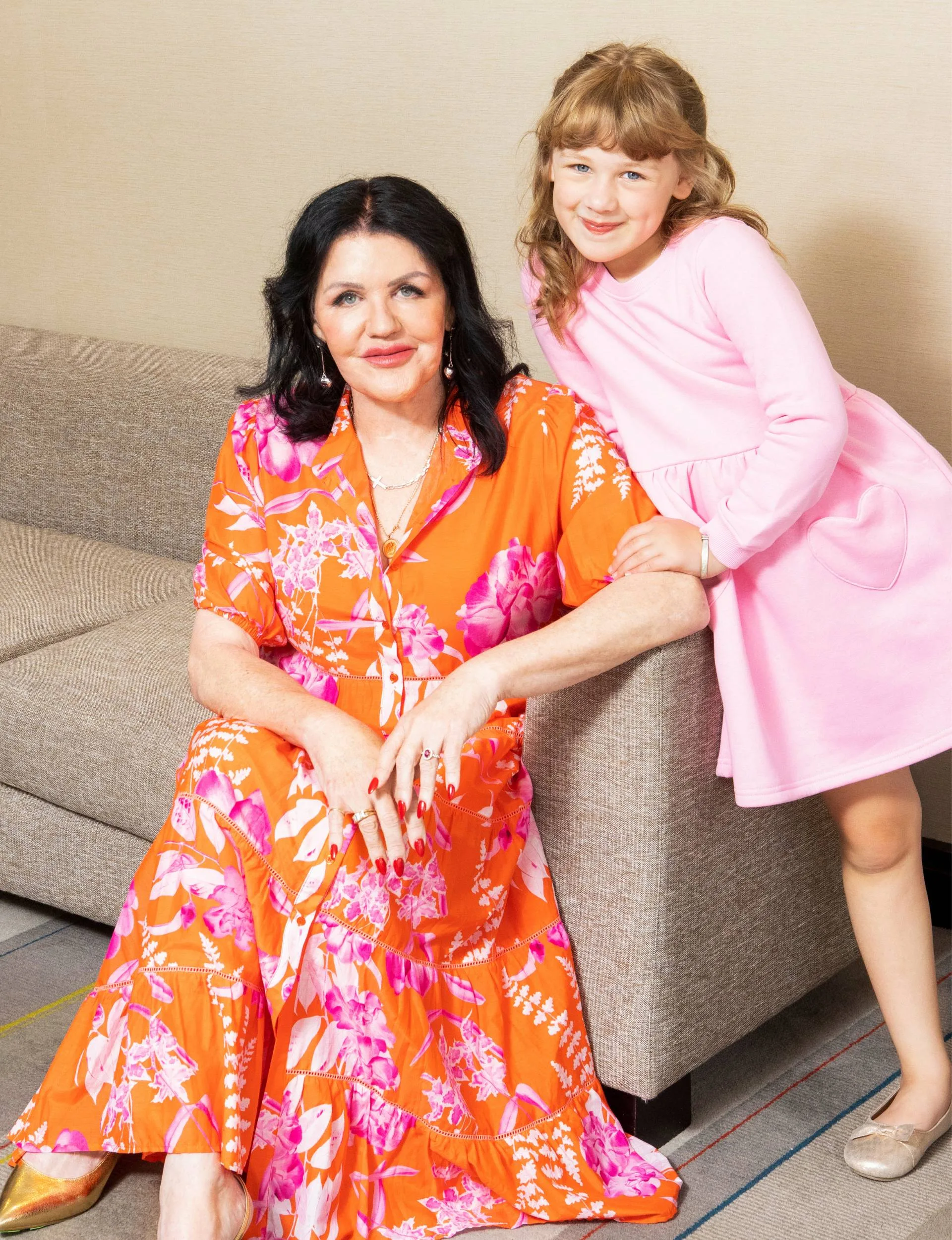 Polly Gillespie sitting on a couch with her granddaughter