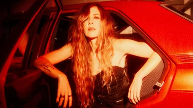 Reb Fountain sitting out of a red car door