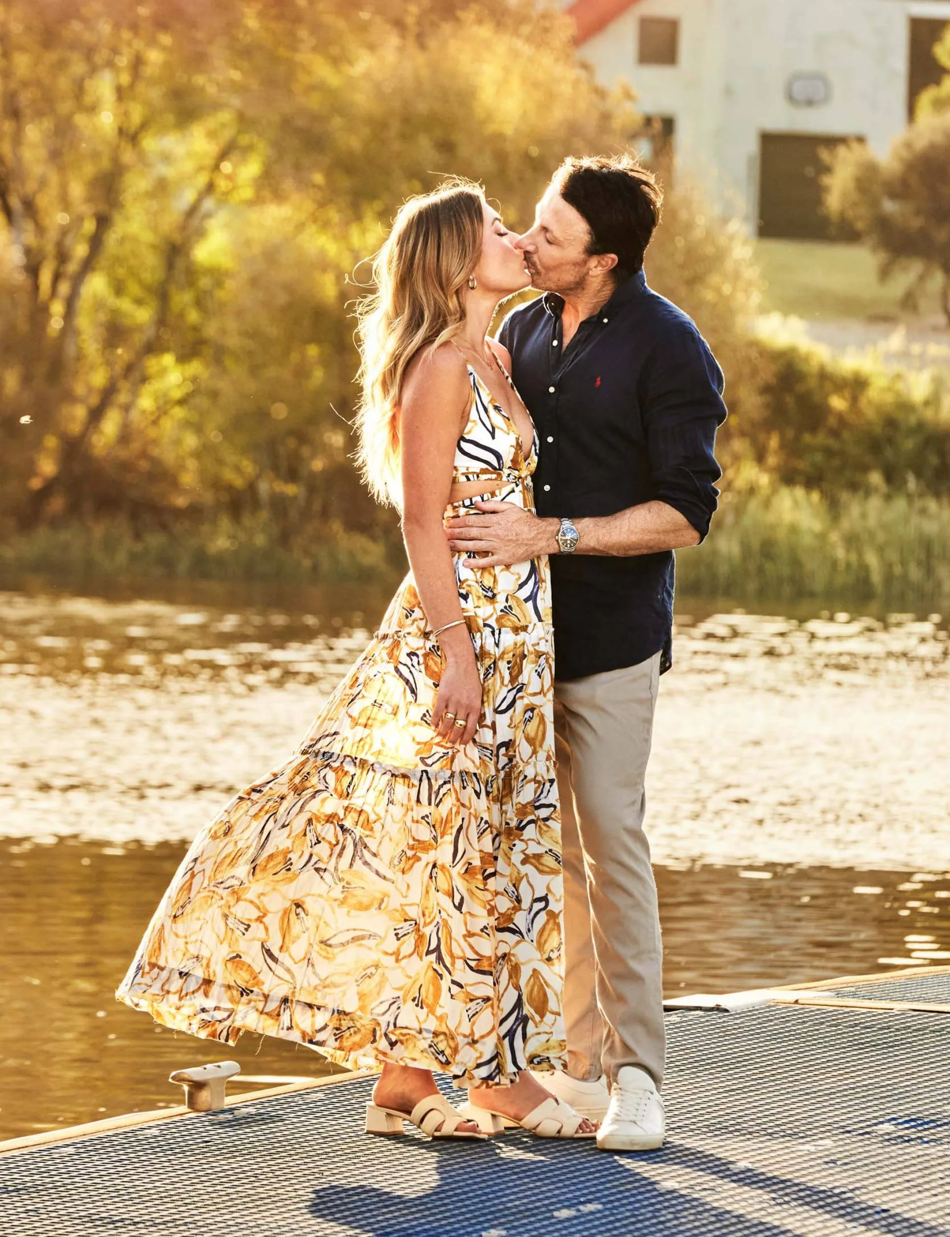 Jacqui and Clint kissing on a wharf