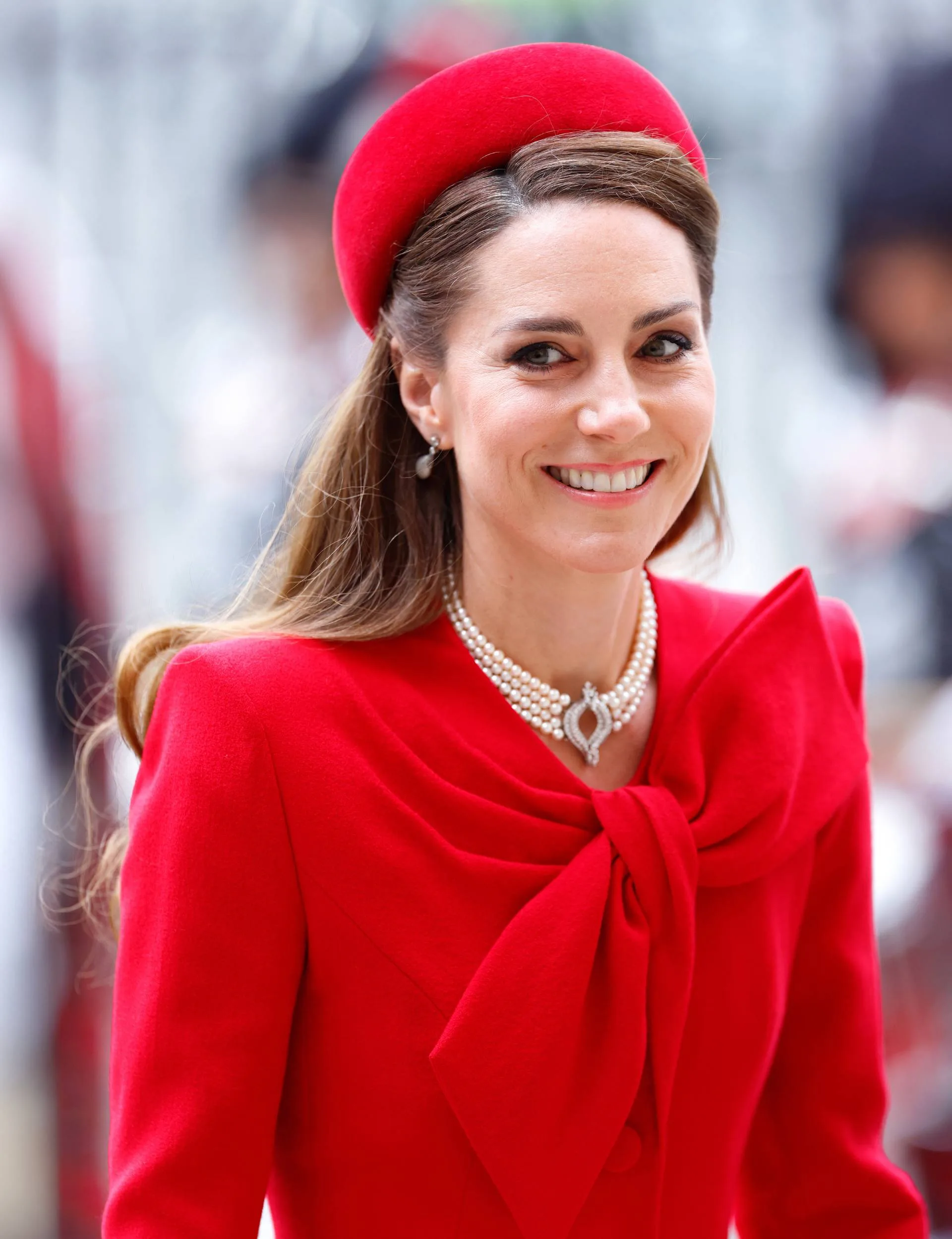 Kate wearing red and smiling