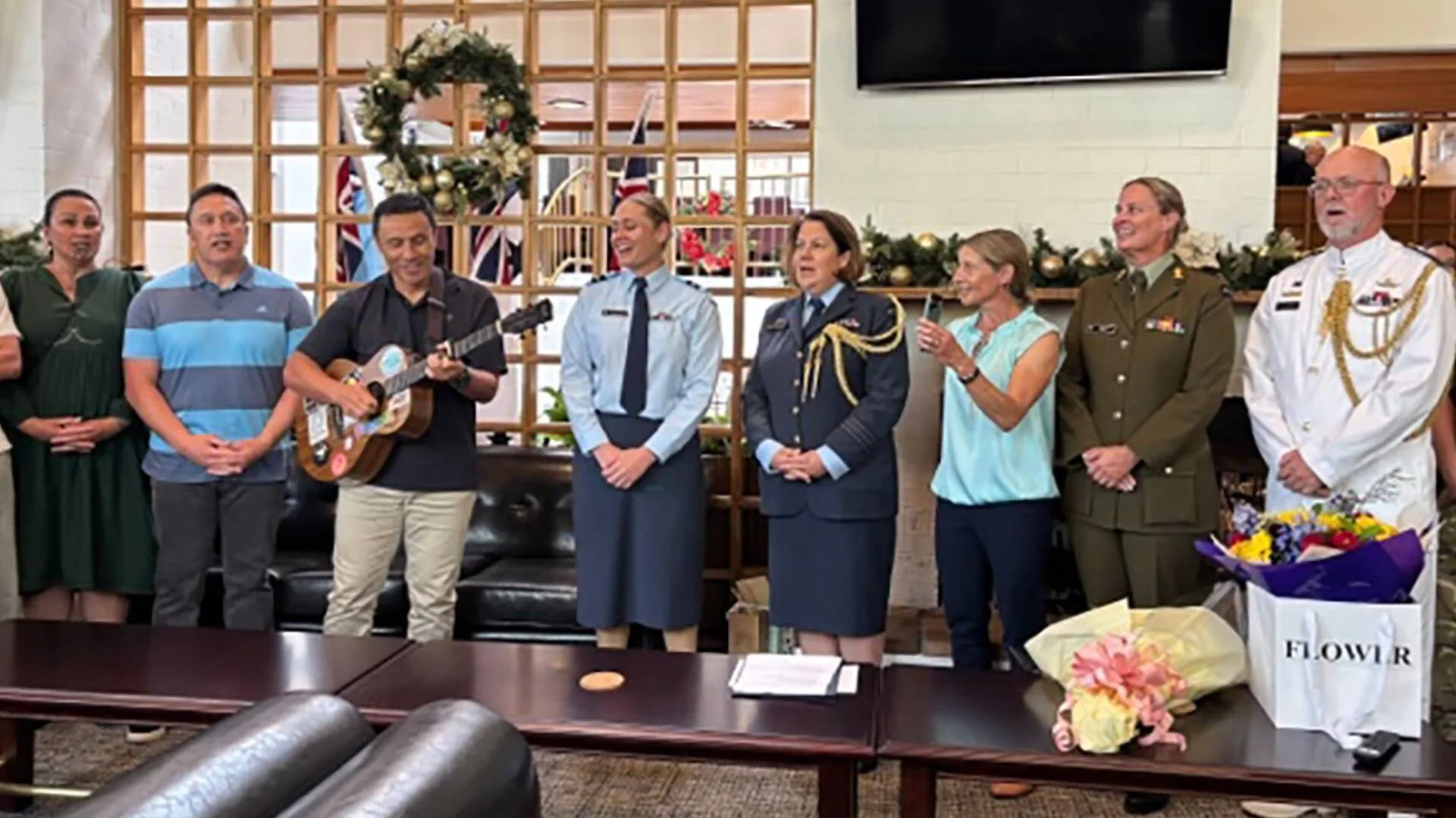 Singing a waiata with her colleagues and support people