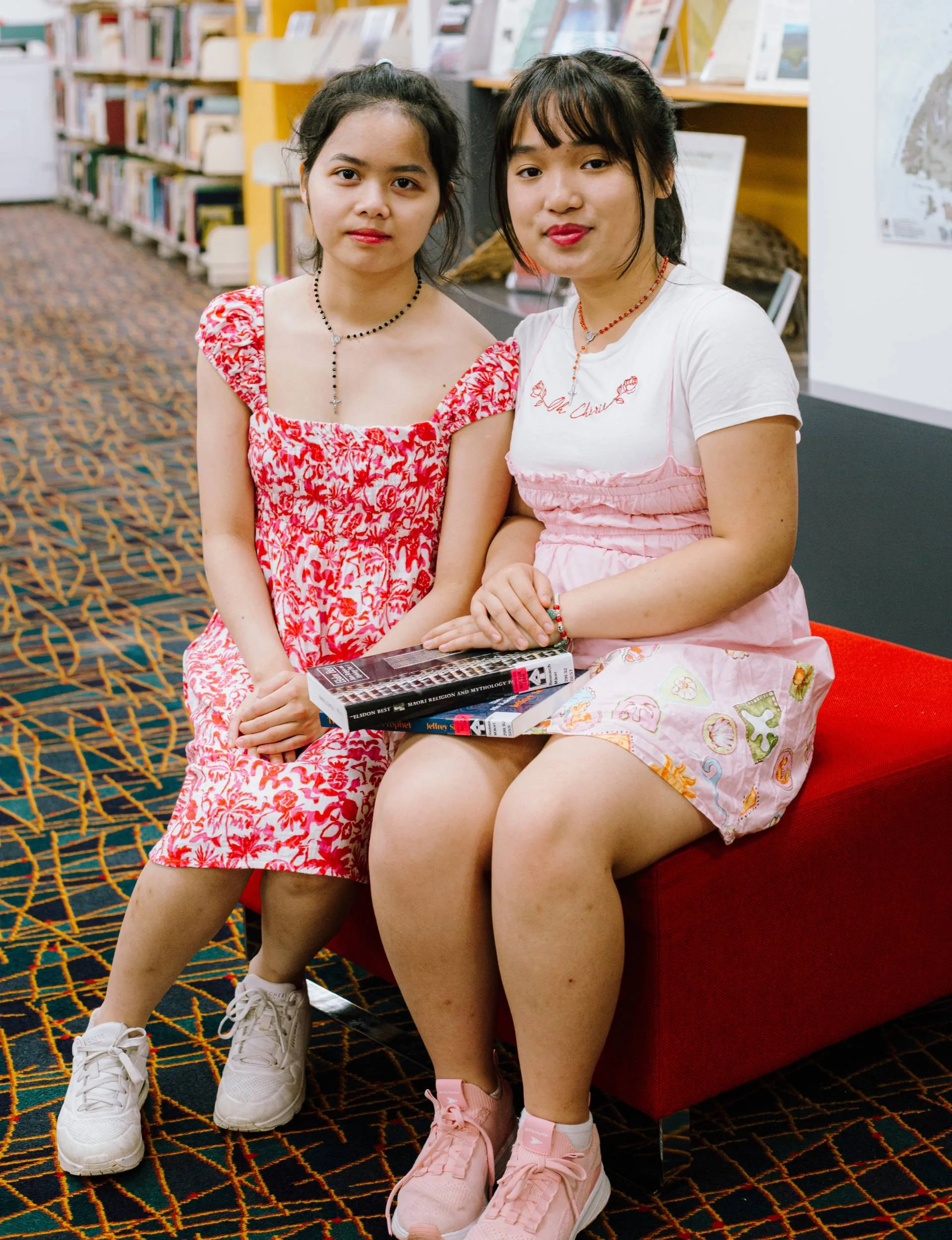 Alisa Pham and Vicky Ngo in a University library