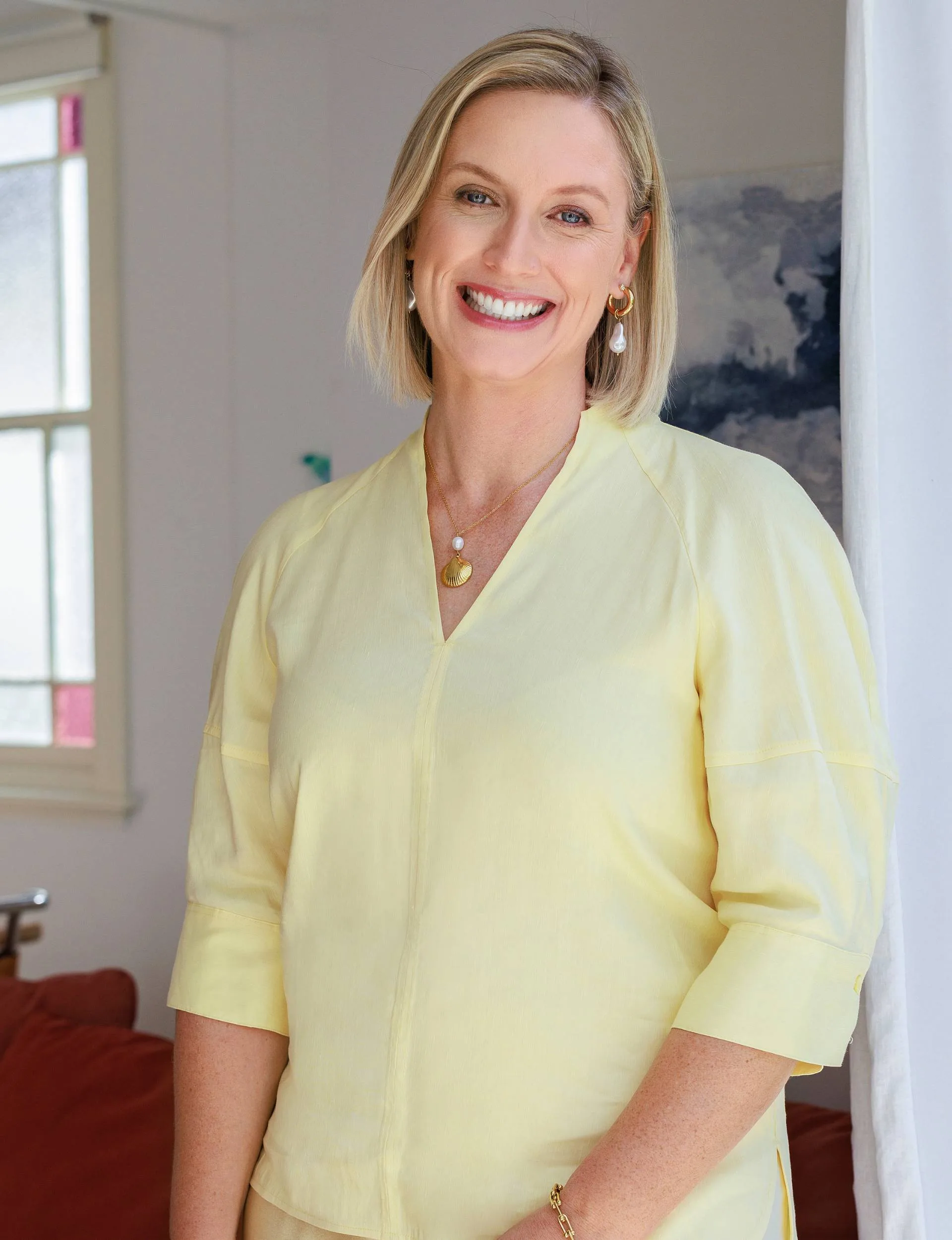 Anna Burns-Francis smiling in a yellow shirt