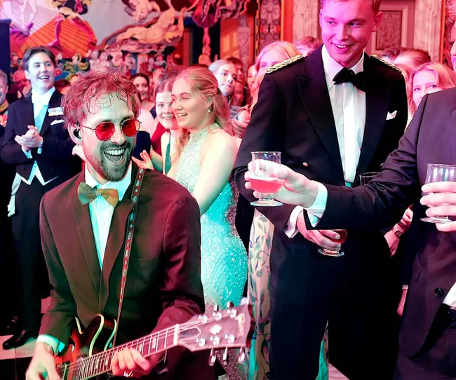 A guitarist playing at Princess Isabella's 18th birthday