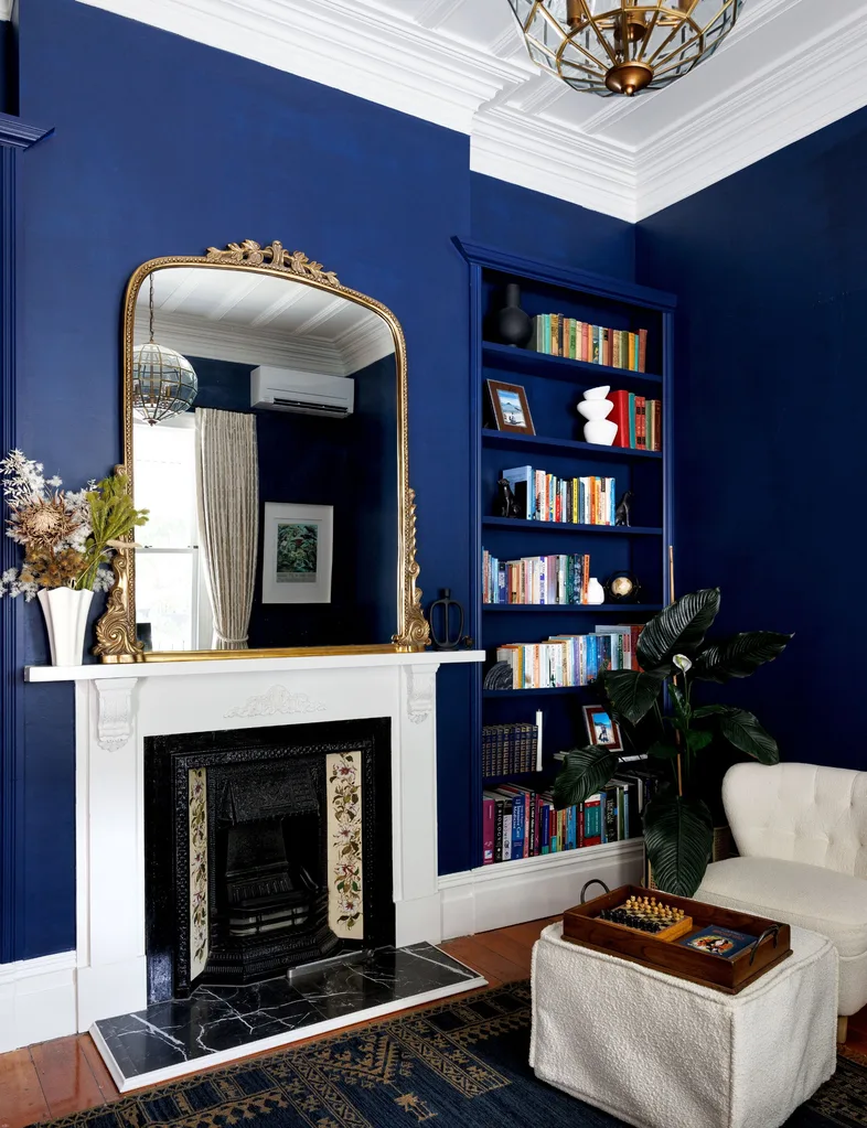 A renovated Auckland villa now has a library painted in a bold blue paint