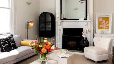 A minimalist living room in this renovated Auckland villa. Bright white walls complemented with black and neutral accents