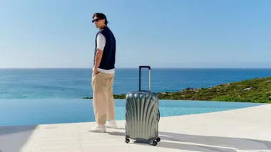 Man alongside Samsonite suitcasse