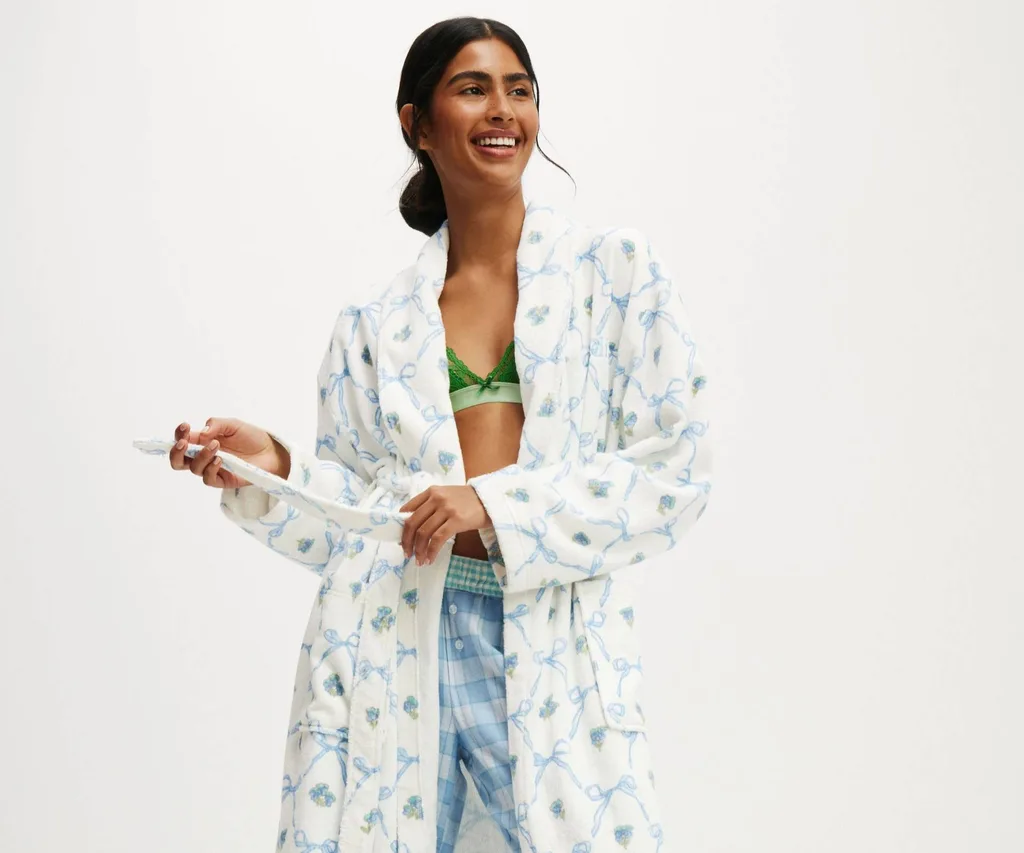 Brunette model wearing bathrobe with bow pattern