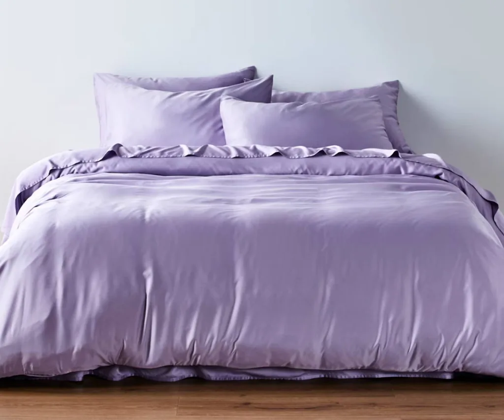 bed with light purple duvet, sheets and pillows
