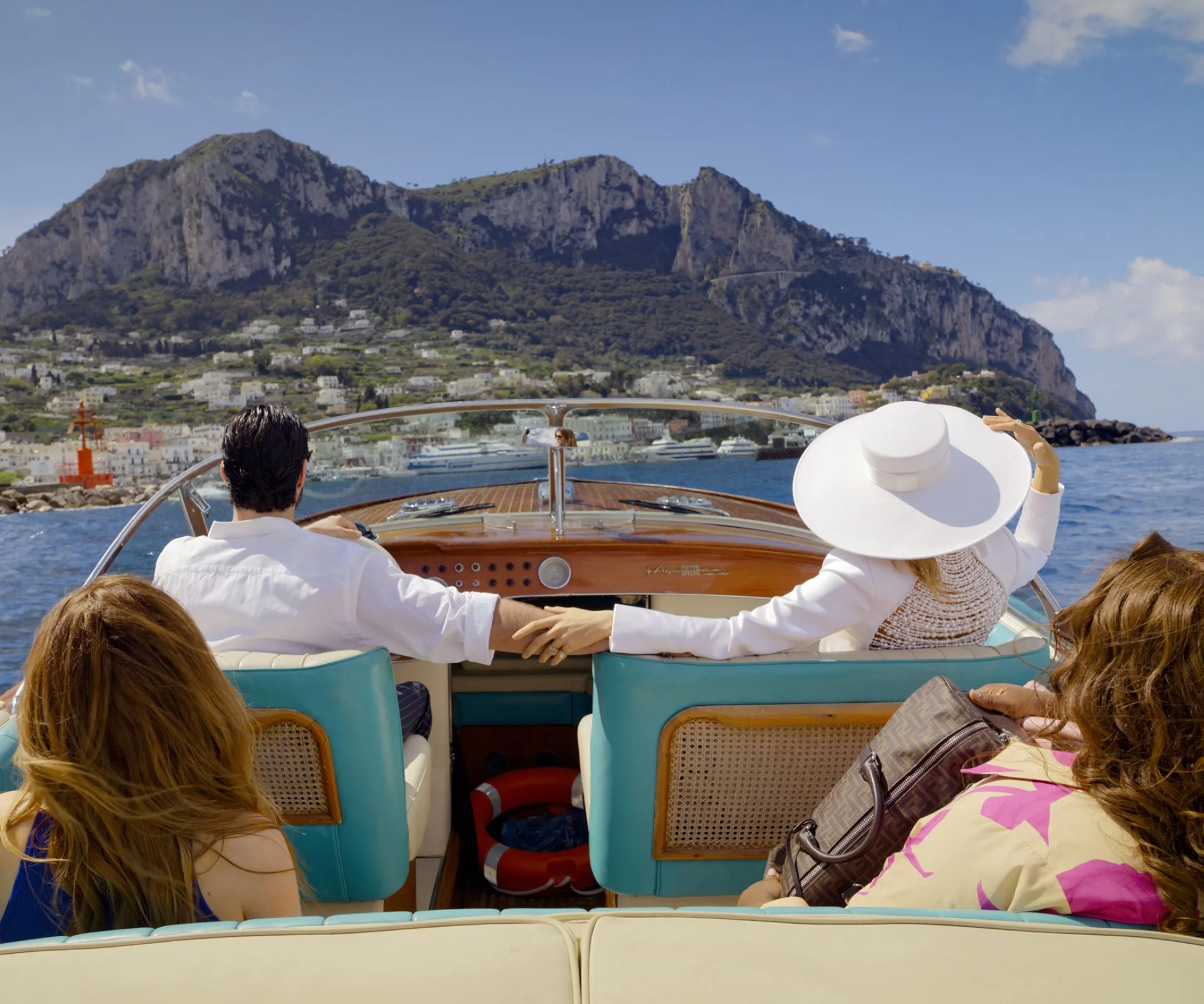 Four people on a boat in Capri in Another Simple Favor