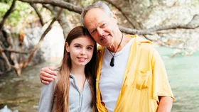 Bruce Hopkins with his granddaughter Gracie on a beach