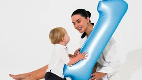 Edna Swart with her son Astyn and a large inflatable '1' balloon