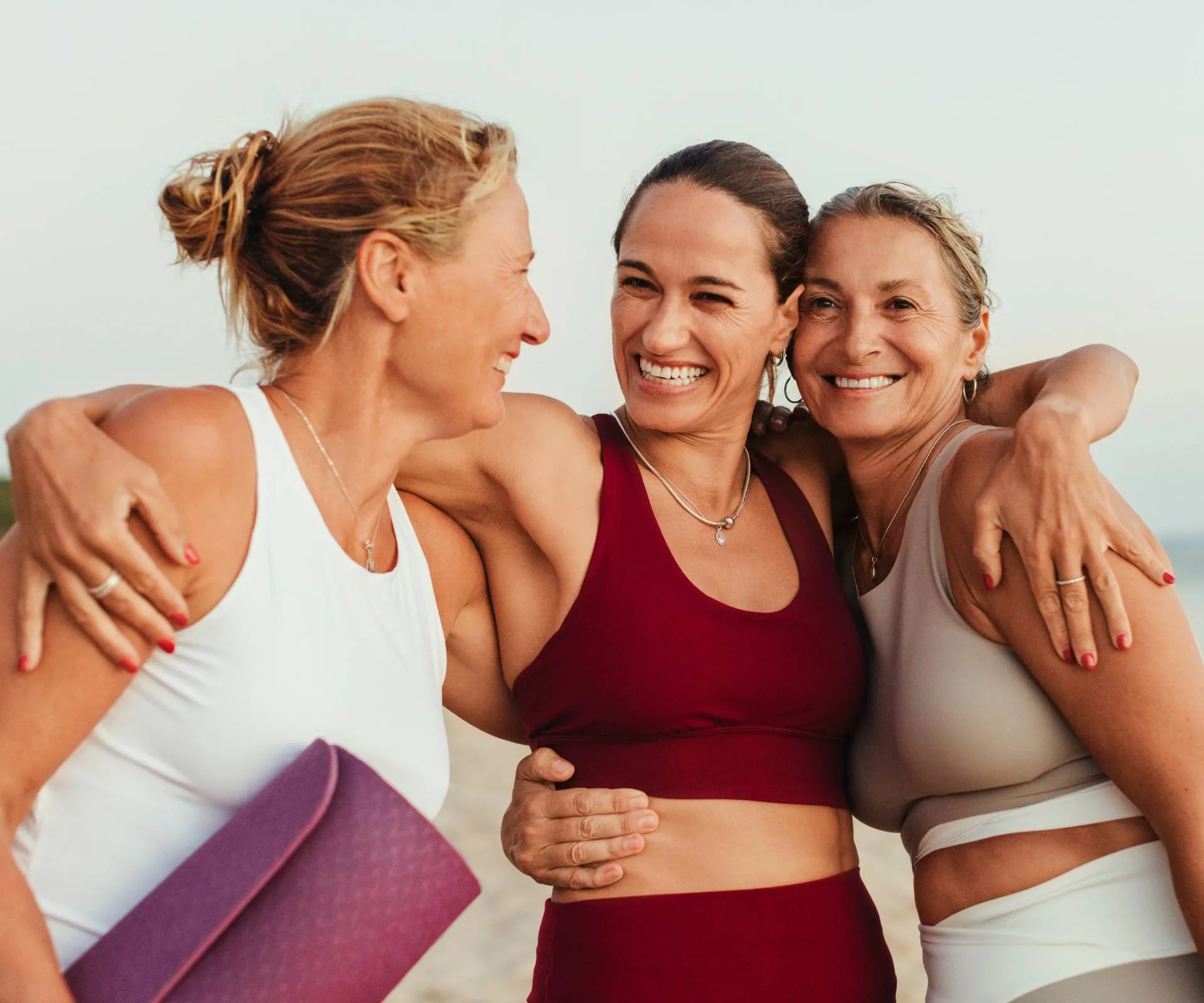 Three women smiling and hugging making small life changes together