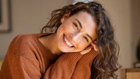 A woman smiling because she made small life changes