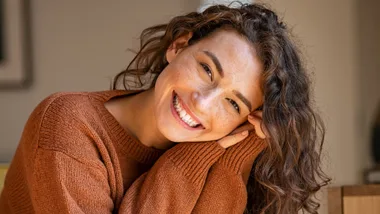 A woman smiling because she made small life changes