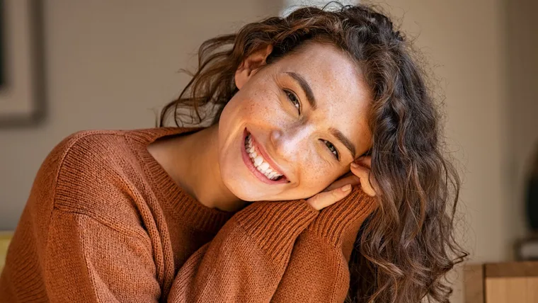 A woman smiling because she made small life changes