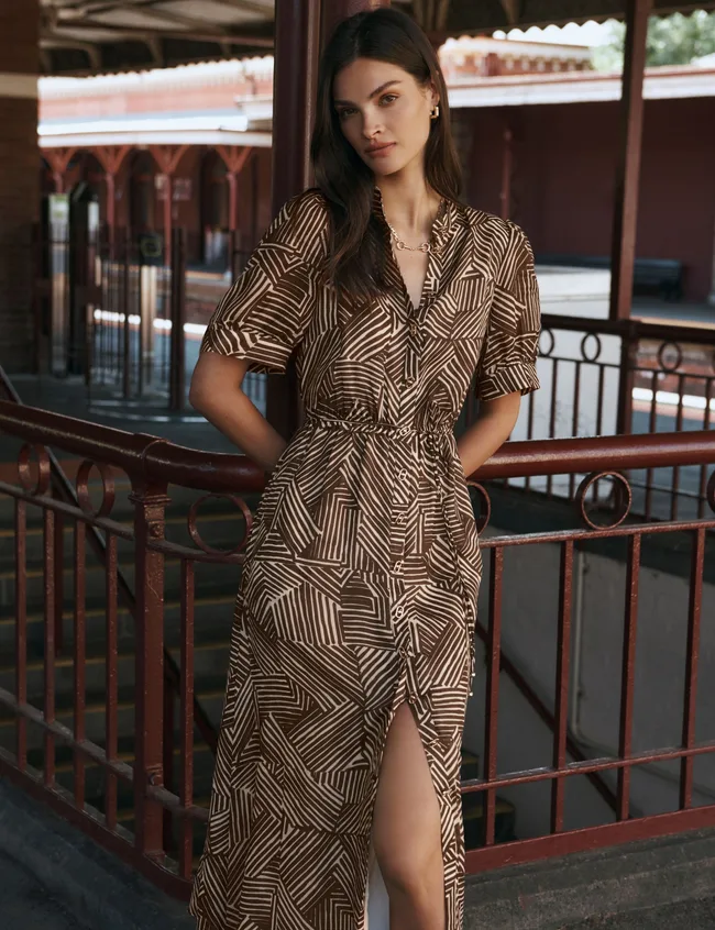 Model wearing floaty short sleeved Forever New dress