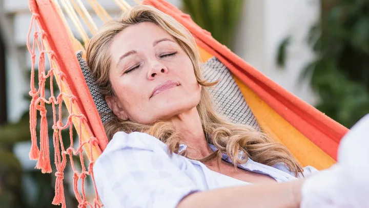 A woman manifesting while laying in a hammock