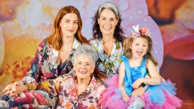 Annah Stretton with her family in front of a floral background
