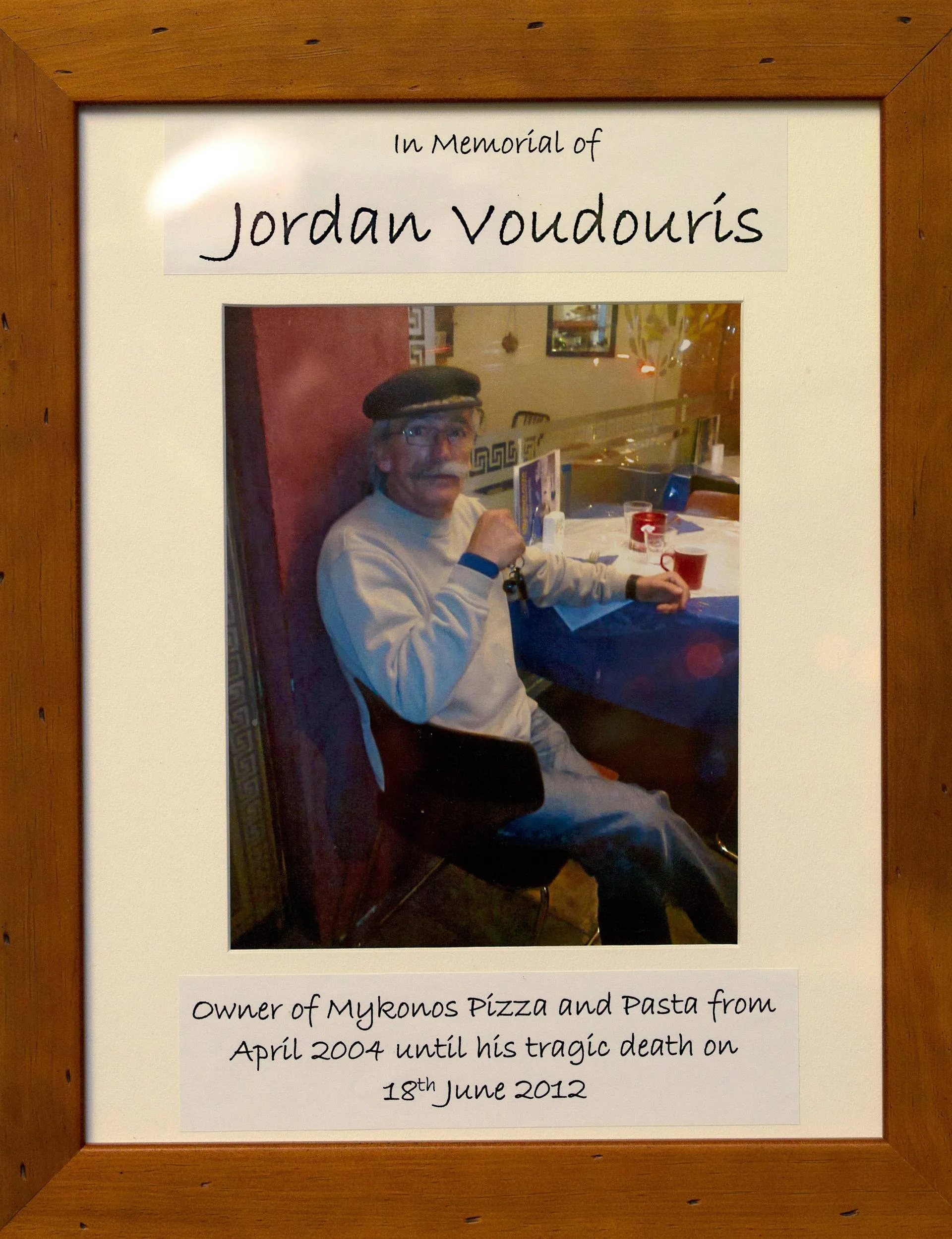 Jordan's memorial card in a wooden frame